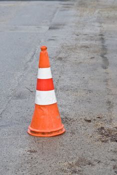 a construction site cap standing on the road as a warning