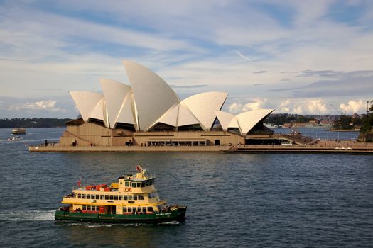  A ferry motors past Sydney Opera House in New South Wales, Australia.