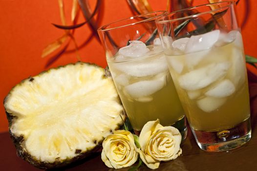 Fruit drink, pineapple, orange roses background