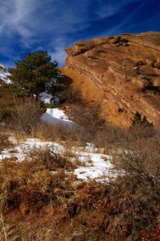 Red Rocks State Park in Colorado showing the colorful hills in snow during winter