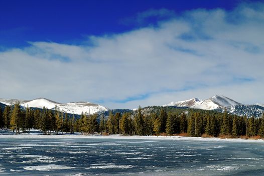 A frozen lake along the Colorado Rockies in Winter