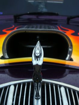 Front end of a Hotrod with air intake and classic hood ornament