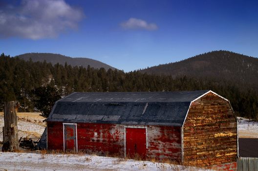 a classic rural red barn in snow