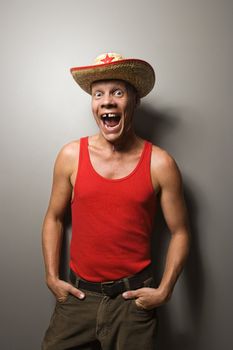 Portrait of a Mid-adult Caucasian male wearing straw hat with expression.