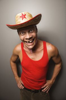 Portrait of a Mid-adult Caucasian male wearing straw hat with funny expression.