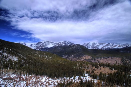 Winter along the Colorado Rockies with snow capped mountain peaks