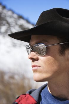 Mid-adult Caucasian male wearing sunglasses and cowboy hat.