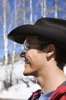 Young adult Caucasian male wearing sunglasses and cowboy hats.