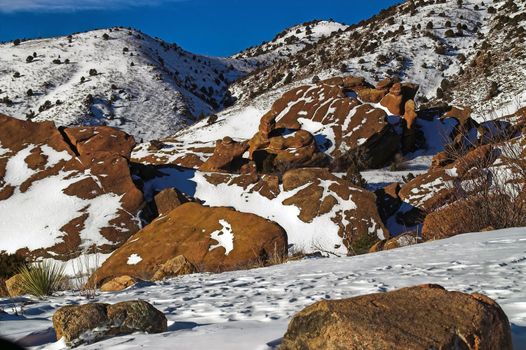 Colorado's Red Rocks State Park in Winter showing morning light among the mountains and snow