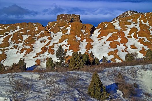 The morning light seems to come alive against the bright blue sky, snow, and wonderful mountains at Red Rocks State Park in Colorado