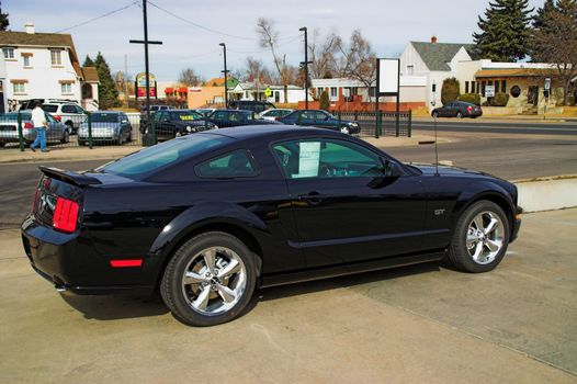 a black late model Ford Mustang
