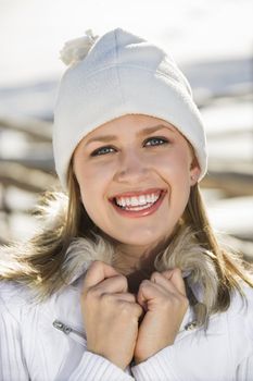 Portrait of a mid-adult Caucasian female holding fur collar.