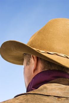Back of a Middle-aged Caucasian male wearing a cowboy hat.