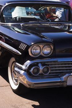 Black Classic Chevy classic car at a car show
