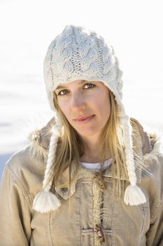 Young adult Caucasian woman in winter attire looking at viewer.