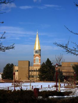 Church Steeple at Denver University, Denver Colorado in Winter against blue sky