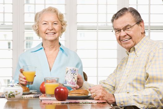 Mature Caucasian couple having breakfast together.