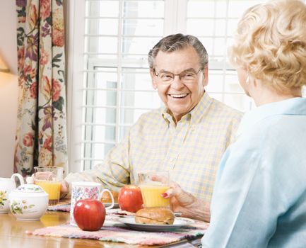 Mature Caucasian couple having breakfast together.