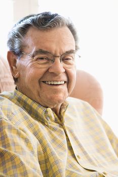 Portrait of mature Caucasian man sitting in chair.