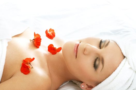 beautiful lady with red flowers in spa