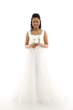 Mid-adult African-American bride holding bouquet on white background.