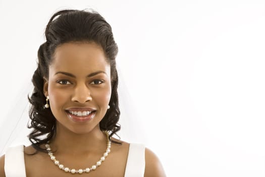 Portrait of a mid-adult African-American bride on white background.