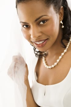 Portrait of a mid-adult African-American bride on white background.