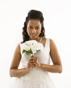 Portrait of a mid-adult African-American bride holding bouquet.