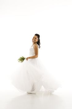 Portrait of a mid-adult African-American bride holding bouquet.