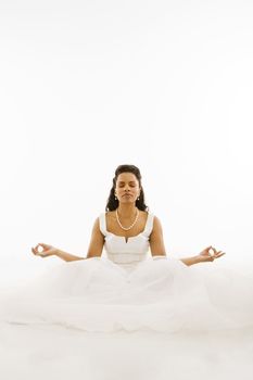 Mid-adult African-American bride mediating with white background.