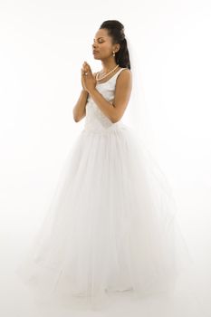 Mid-adult African-American bride praying with white background.