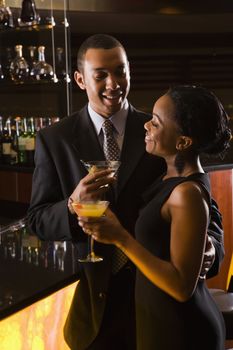 African-American couple having drinks at the bar.