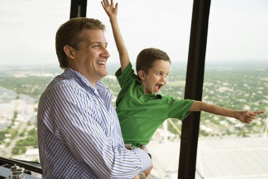 Caucasian father and son at observation deck at Tower of the Americas in San Antonio, Texas.