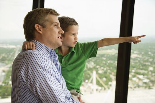 Caucasian father and son at observation deck at Tower of the Americas in San Antonio, Texas.