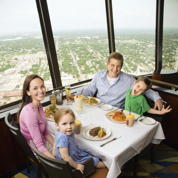 Caucasian family having dinner together at Tower of Americas restaurant in San Antonio, Texas.