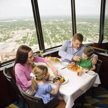 Caucasian family having dinner together at Tower of Americas restaurant in San Antonio, Texas.