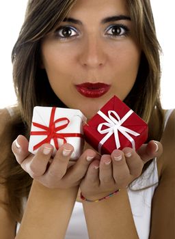 Christmas season! Different poses of a beautiful woman with small gifts on the hands. (Focus is on the gifts)