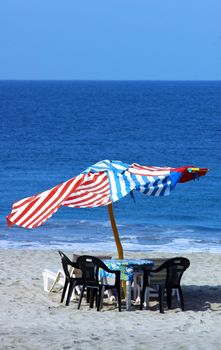 colorful beach umbrellas with seats