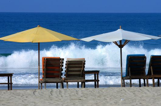 colorful beach umbrellas with seats