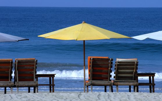 colorful beach umbrellas with seats