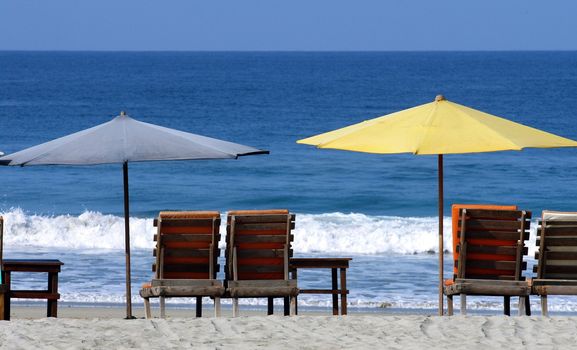 colorful beach umbrellas with seats