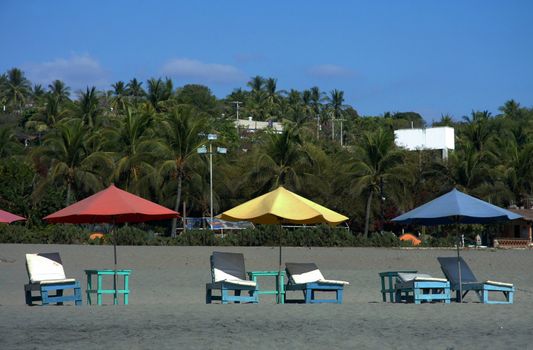 colorful beach umbrellas with seats