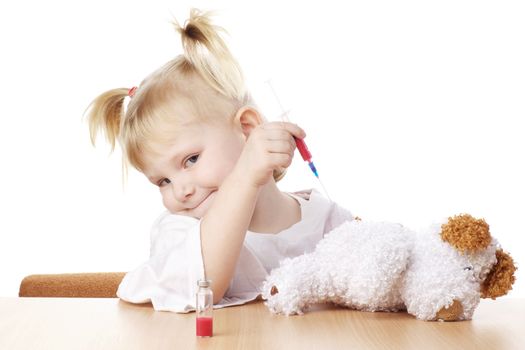 child playing as a doctor with syringe