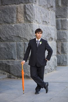 handsome groom with umbrella