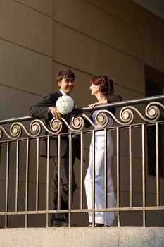 couple near the fence in the city