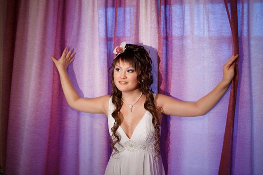 bride near the window with curtains