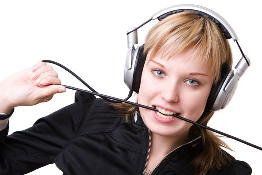 a girl plays with a cable of the earphones listening to the music