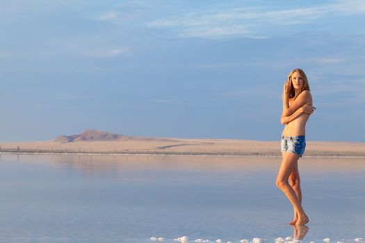 girl in a salt lake in a sunrise