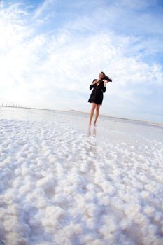 girl in a salt lake in a sunrise