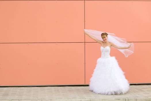 young bride near the wall